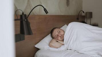 Good Morning. lazy man happy waking up in the bed rising hands to window in the morning with fresh feeling relax video