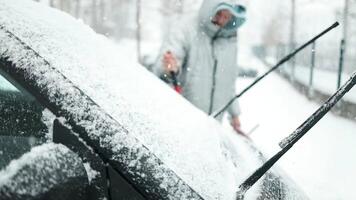 Clearing and remove snow from windshield, Scraping ice. Winter season car window cleaning. video