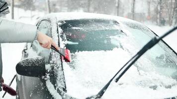 Clearing and remove snow from windshield, Scraping ice. Winter season car window cleaning. video