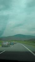 View from the window of the mountains in the car's rearview mirror. Travel by personal car, concept. video