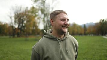 Young caucasian man smiling happy standing at the park. video