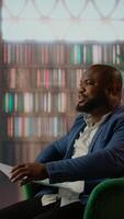 Vertical Team of diverse secret agents analyzing evidence and paperwork in the HQ library, emphasizing strategic thinking to accomplish a national safety surveillance mission. Critical documents. Camera A. video