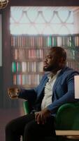 Vertical Businessmen in a classy library discuss partnership goals over whiskey, reflecting trust, success and the luxury of elite social circles. Upper class society members meeting at the club. Camera A. video