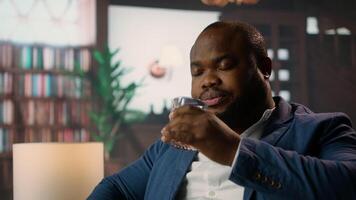 High society billionaire drinking whiskey at the classy luxurious social club, enjoying a gathering with the upper class members. Elegant gentlemen with successful careers. Camera A. video