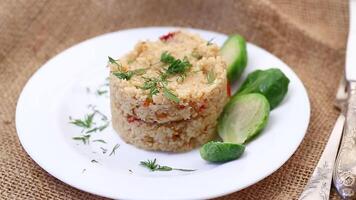 homemade cooked bulgur with Brussel sprouts in a plate, on a wooden table video