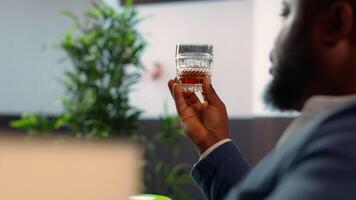 Two diverse high society members in a private gentlemen club discussing career advancement and opportunities while enjoying a sophisticated whiskey experience. Old money billionaires. Camera A. video
