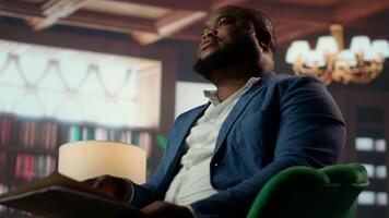Aristocrat presents a promising business venture over whiskey glasses in a classy vintage style club, embodying elite social networking between upper class society members. Billionaires. Camera B. video