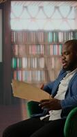 Vertical Intelligence agents analyzing sensitive information over a drink, portraying teamwork, professionalism and the essence of a secret mission briefing. Top secret data at the bureau library. Camera A. video