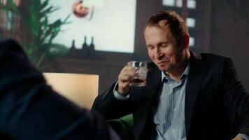 Drunk upper class elite society member being loud and obnoxious at the social club, embarrassing himself due to alcohol intoxication. Gentlemen in a state of euphoria after whiskey drinks. Camera B. video