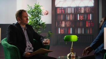 Government agents discuss confidential data stored on a SSD, intelligence services protect state secrets. Spies review crucial information on a system unit, drinking whiskey together. Camera A. video