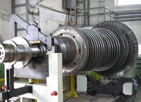 Industrial medium pressure turbine rotor on a balancing machine in a workshop. Mechanical engineering. Power engineering. photo
