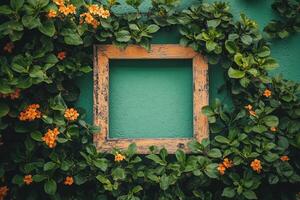 A rustic frame surrounded by vibrant green foliage and orange flowers on a teal wall. photo