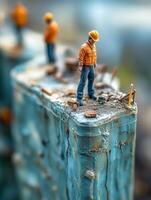 Miniature construction workers on a building site, showcasing detailed craftsmanship. photo