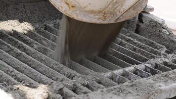 Wet concrete pouring from a cement mixer video