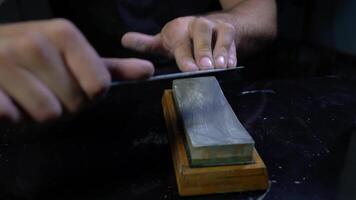 Man sharpening knife, close up video