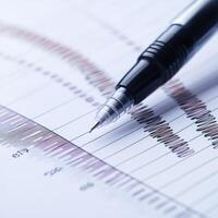 Detailed analysis of data trends with a pen on a report showcasing fluctuating statistics photo