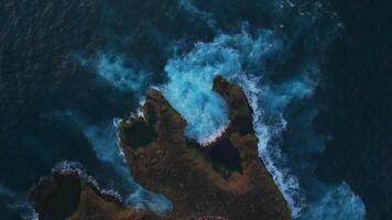 Waves crashing and splashing on the rocks, drone view video