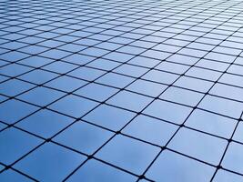 Geometric Pattern of a Wire Fence Against a Clear Blue Sky Capturing Minimalist and Modern Design Elements photo