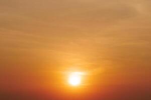 Stunning Golden Sunset Over Tranquil Horizon with Soft Clouds and Warm Light Creating a Serene and Peaceful Atmosphere photo