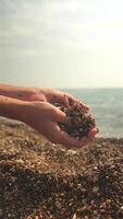 Hands Releasing Pebbles on Beach in Slow Motion Close-Up video