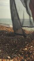 Close-Up of Womans Legs in Black Swimsuit and Pareo Walking Out to Sea video