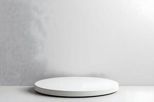 A white round table with a white surface in front of a wall photo