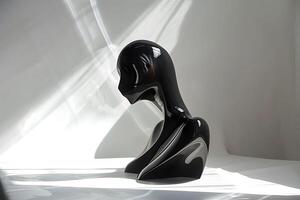 A black sculpture on a white surface photo