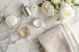 White flowers and a towel on a marble counter photo
