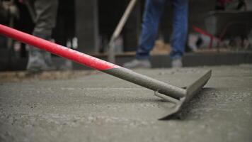 Workers Leveling Wet Concrete at Construction Site video