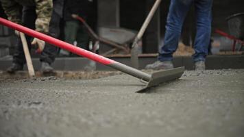 Workers Leveling Wet Concrete at Construction Site video