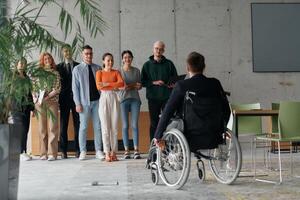 Multiethnic Business Team Collaborating in a Modern Office with Director in a Wheelchair photo