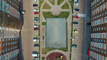 City life in modern complex. Comfortable playground and car parking between the apartment buildings of the urban district. Top down view. video