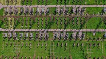Power transmission lines. Flight over high voltage pillars on green field background. Aerial view. video