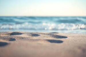Footprints in the sand at the beach photo