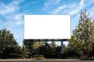 Blank billboard on the road with trees and sky photo