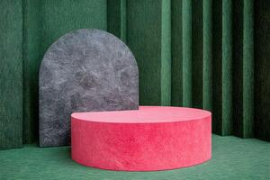 A pink and black round table in front of a green wall photo