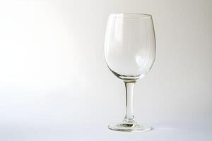 A wine glass is shown on a white background photo