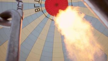 Goreme, Turkey, 2024 - inside view flames and inflating Hot air balloon in Cappadocia. The place where the balloons take off.Preparation of the balloon with basket for take-off video