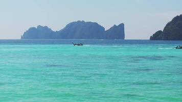 Aerial view of Thailand's Phi Phi Islands, showcasing turquoise waters, lush greenery, and dramatic limestone cliffs rising from the sea. video