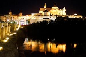 Beautiful panoramic view of the Roman bridge with the cathedral mosque in the background photo