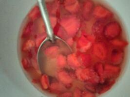 Closeup of a bowl of sliced strawberries photo