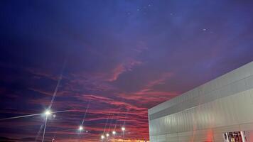Modern Building at Dusk with Red and Purple Sky photo