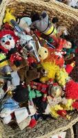 Assortment of Handcrafted Textile Toys in Wicker Basket photo
