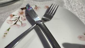 Knife, Fork, and Floral-Patterned Plate photo