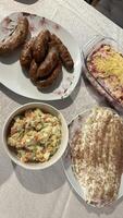 Sausages, Vegetable Salad, Casserole, and Layered Dessert photo