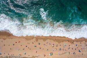 Overhead drone shot of anonymous tourists and parasols on seashore photo