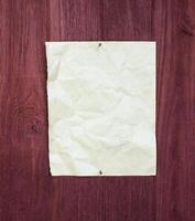 Crumpled paper document on wooden surface still life photography natural lighting close-up view photo