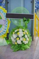 Funeral wreath or flowers with a set of offerings to be placed at the cremation site or used at the funeral. photo