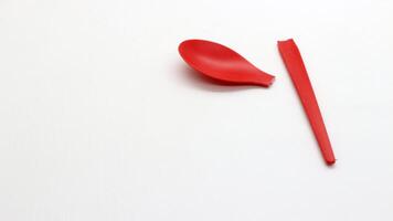 Broken red plastic spoon isolated-1 photo