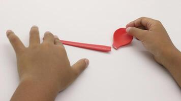 a child's hands are holding two red plastic spoons-6 photo